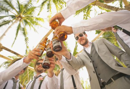 A group of men celebrating at a wedding.